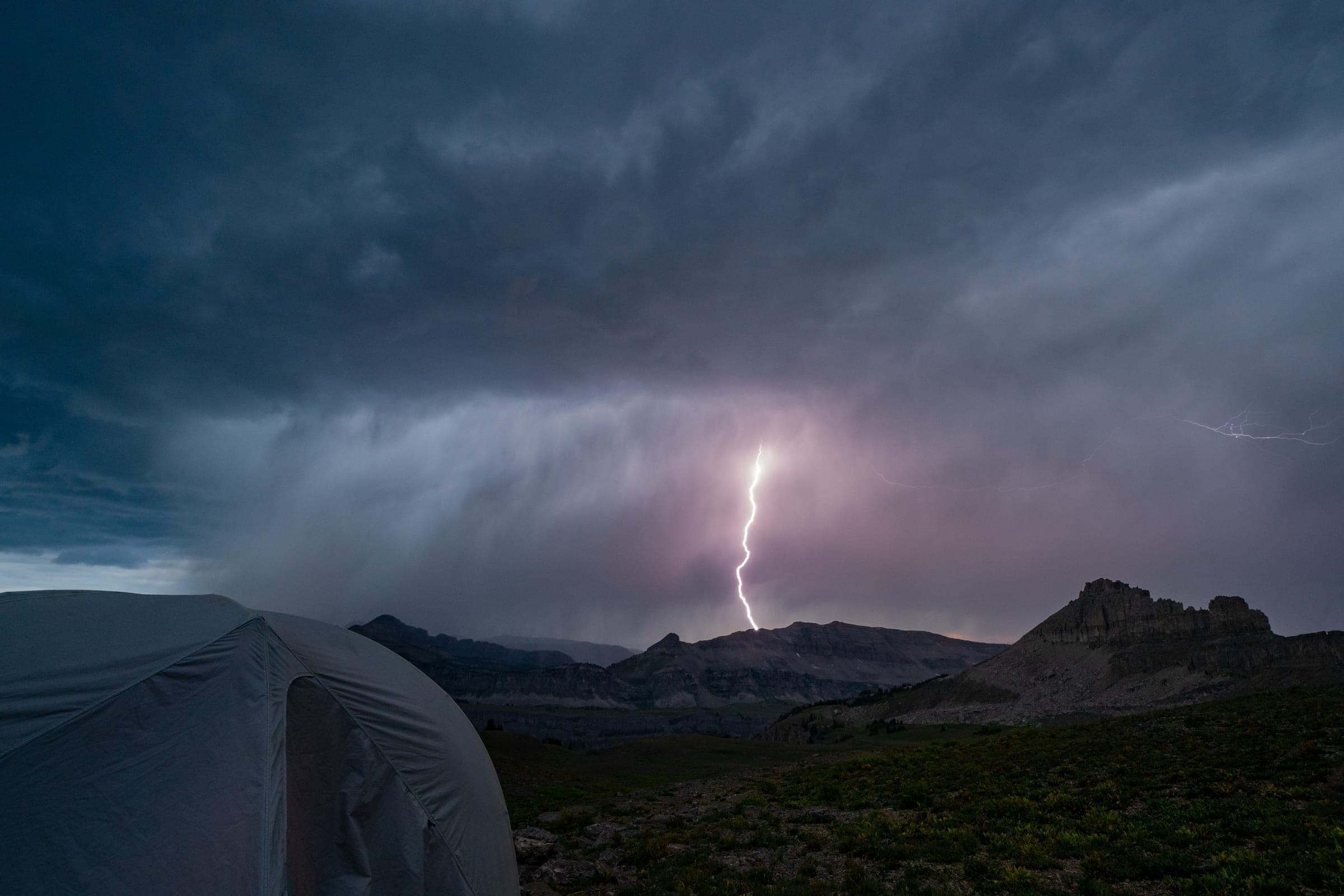 Lightning strike over the Teton Crest from a tent doorway