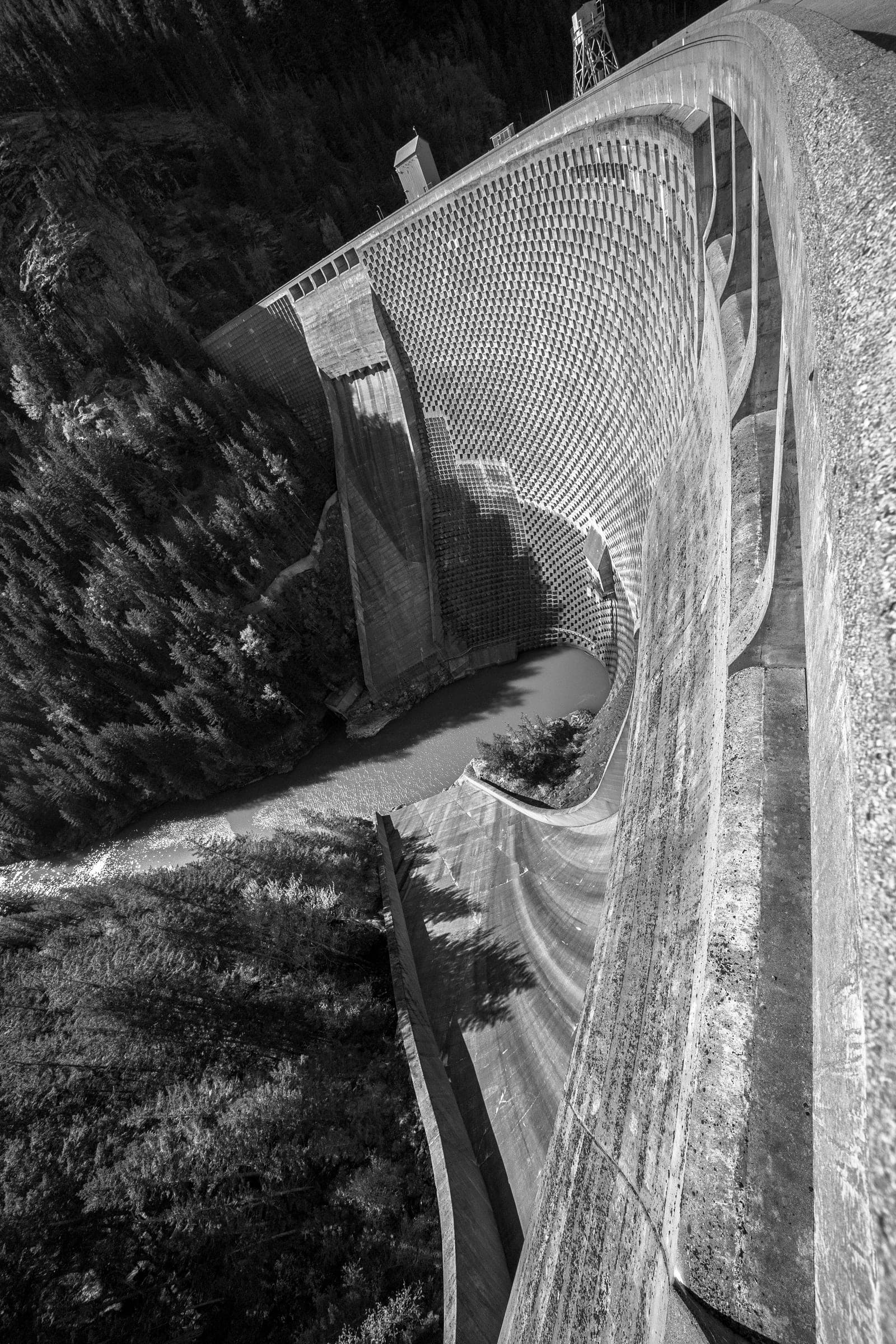 B&W portrait of the Diablo Dam sluice gates curving into the gorge