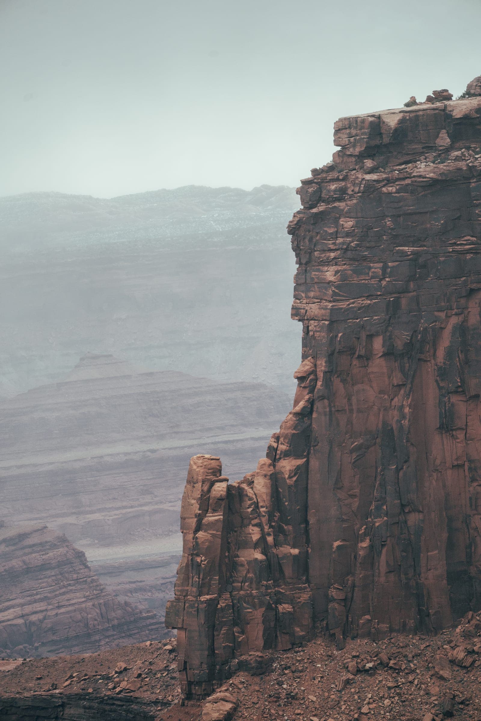 Lone sandstone tower against layered mist