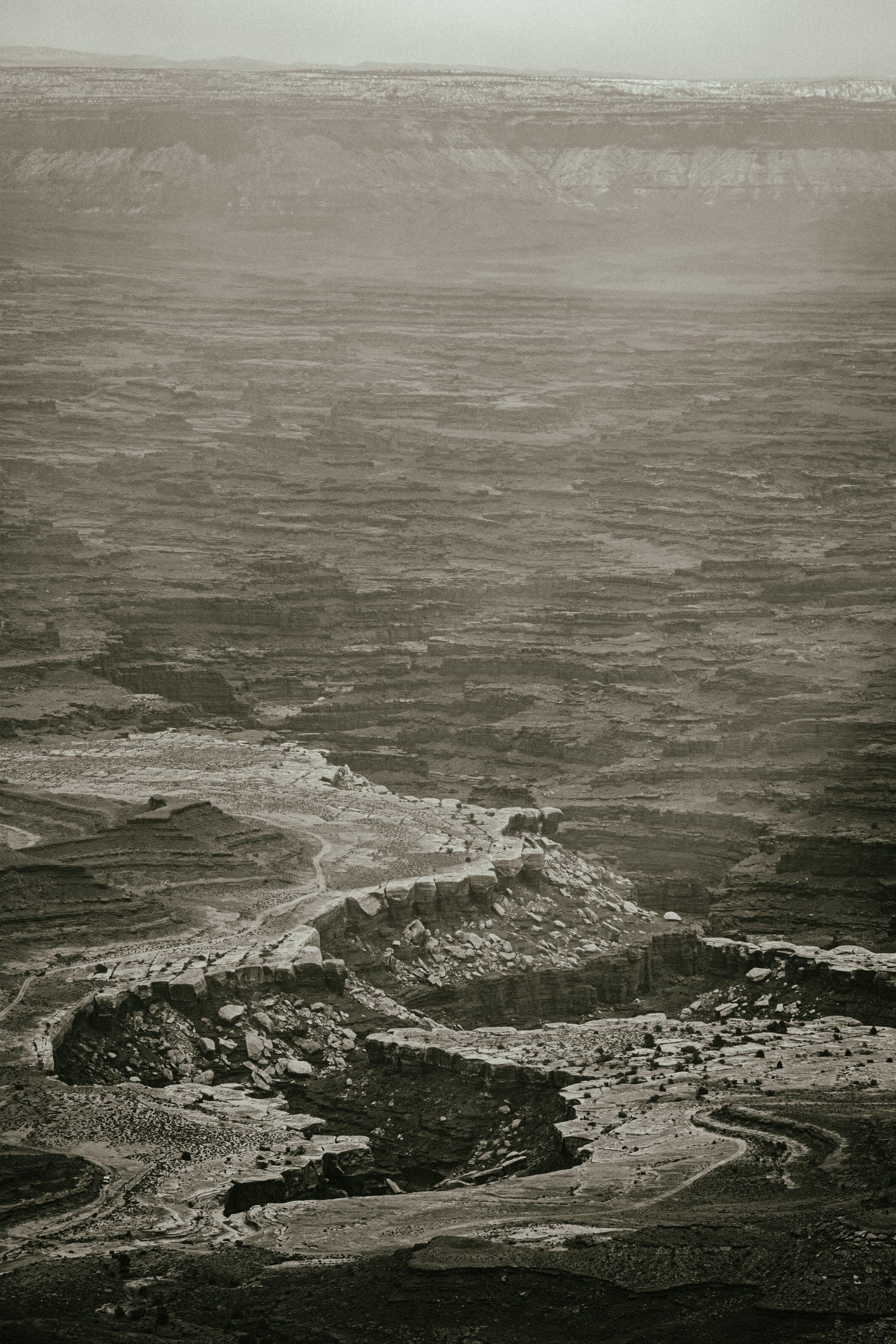 Sepia river bends receding into storm haze