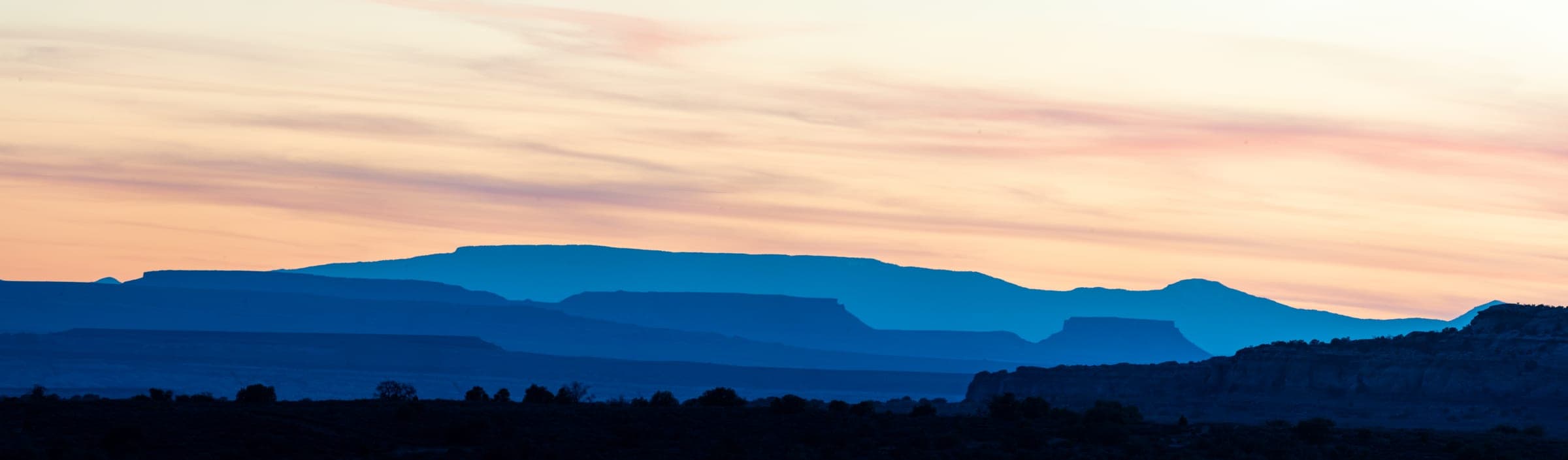 Layered blue mesas at dusk