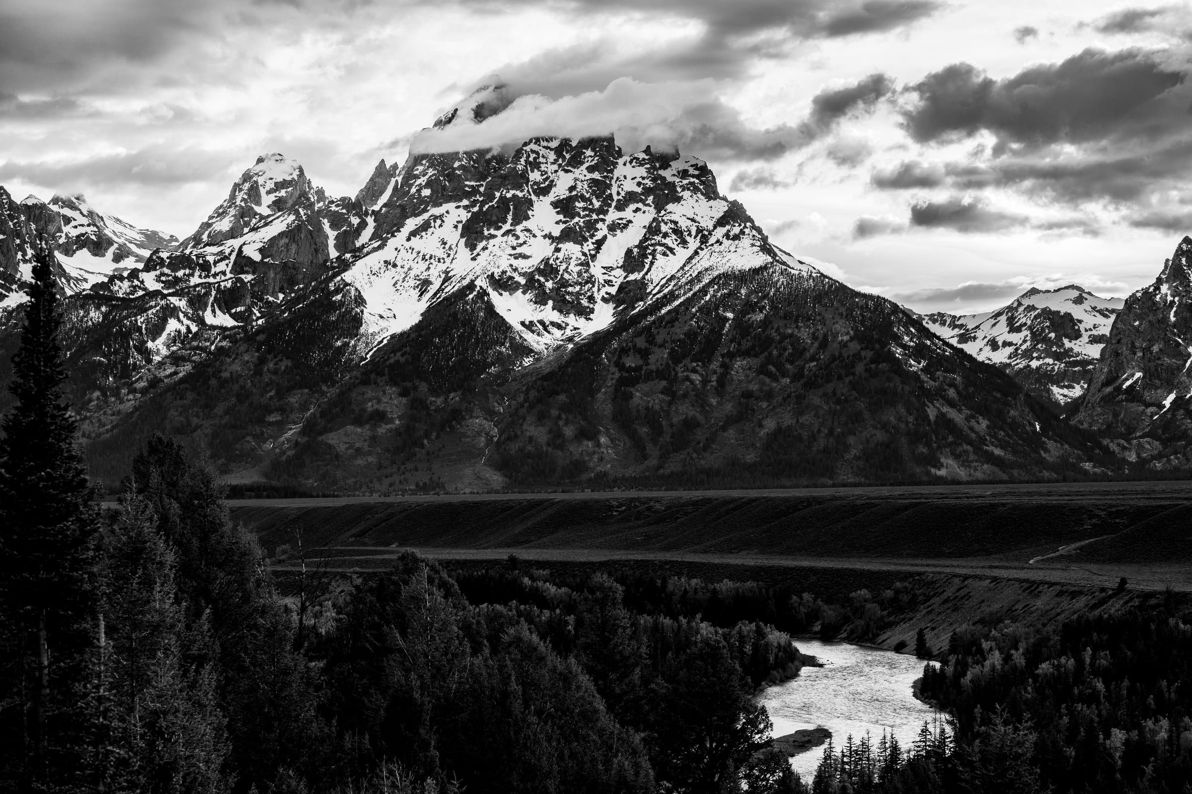 B&W Tetons above the Snake River with storm light