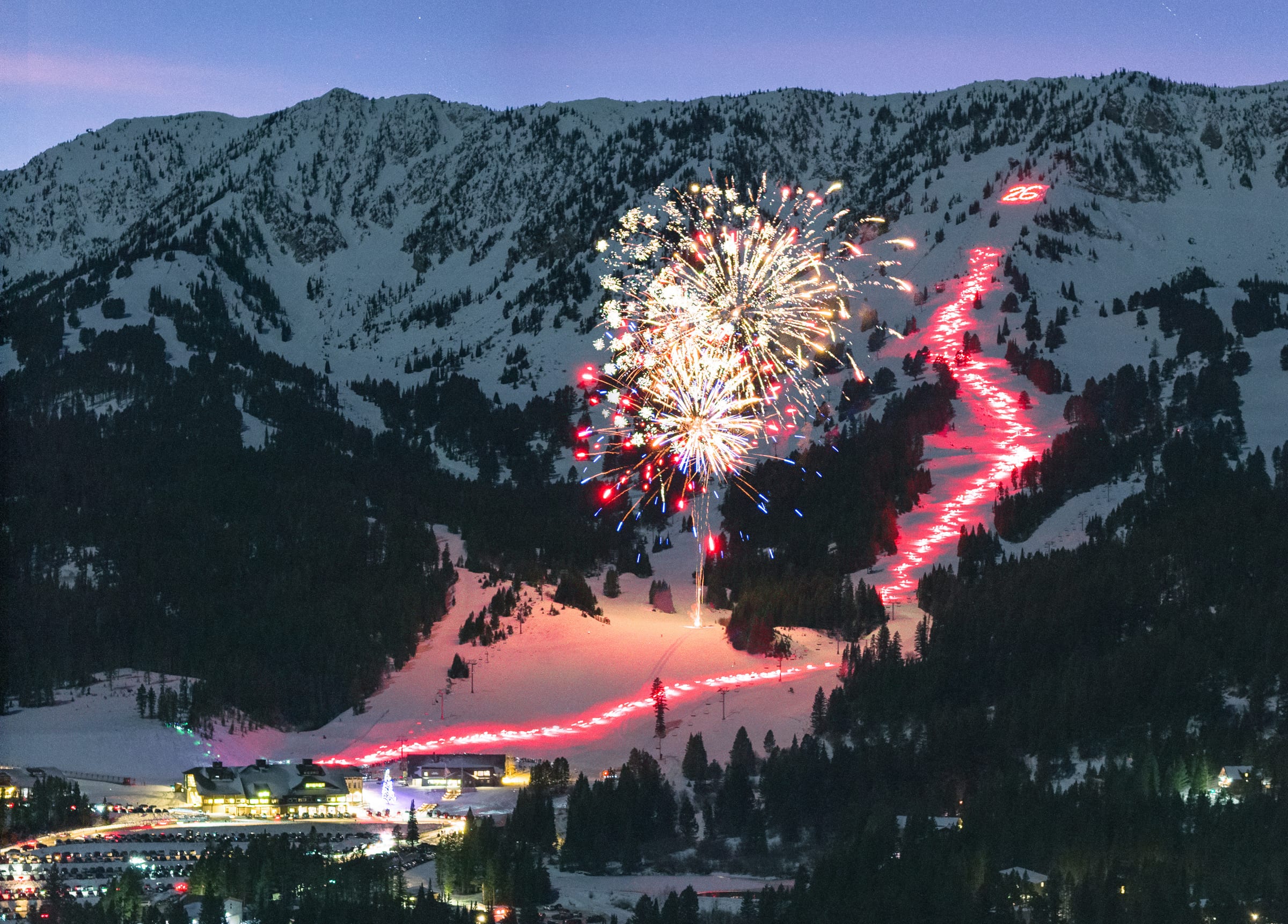 Bridger Bowl torchlight parade zig-zagging under New Year fireworks