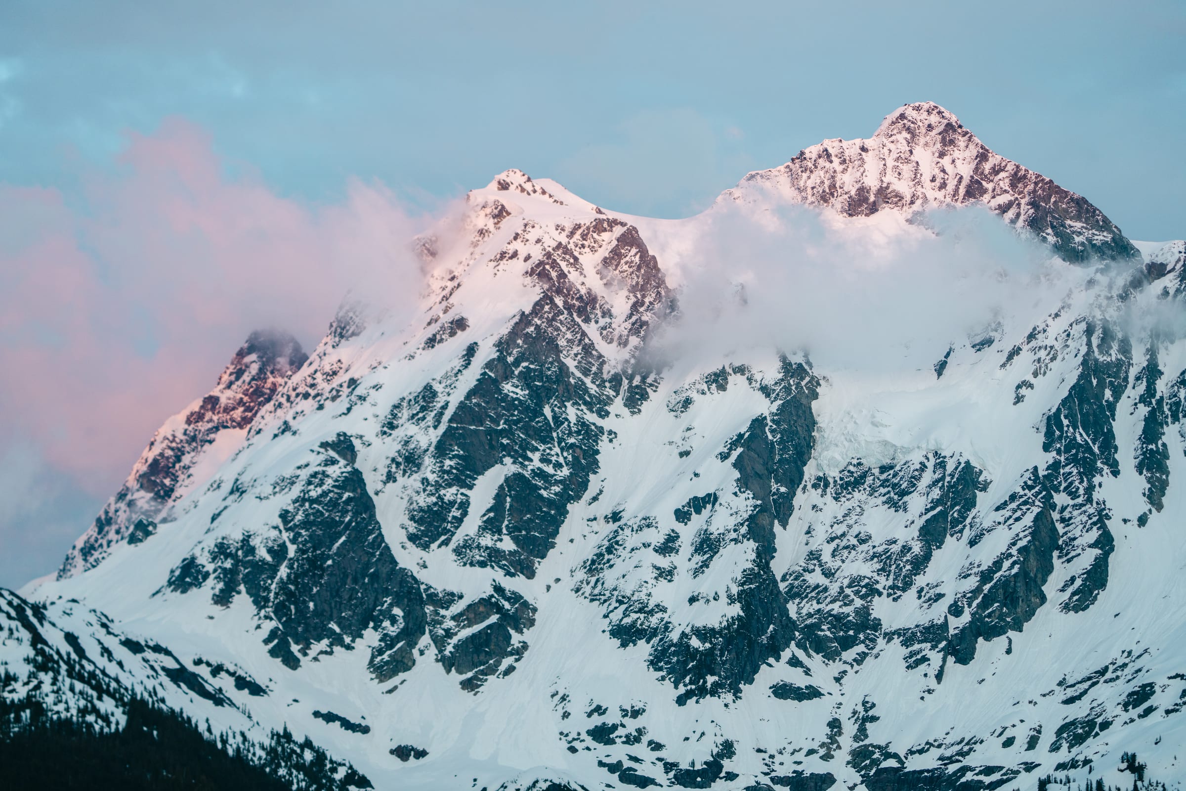 Shuksan in pink alpenglow wrapped in cloud