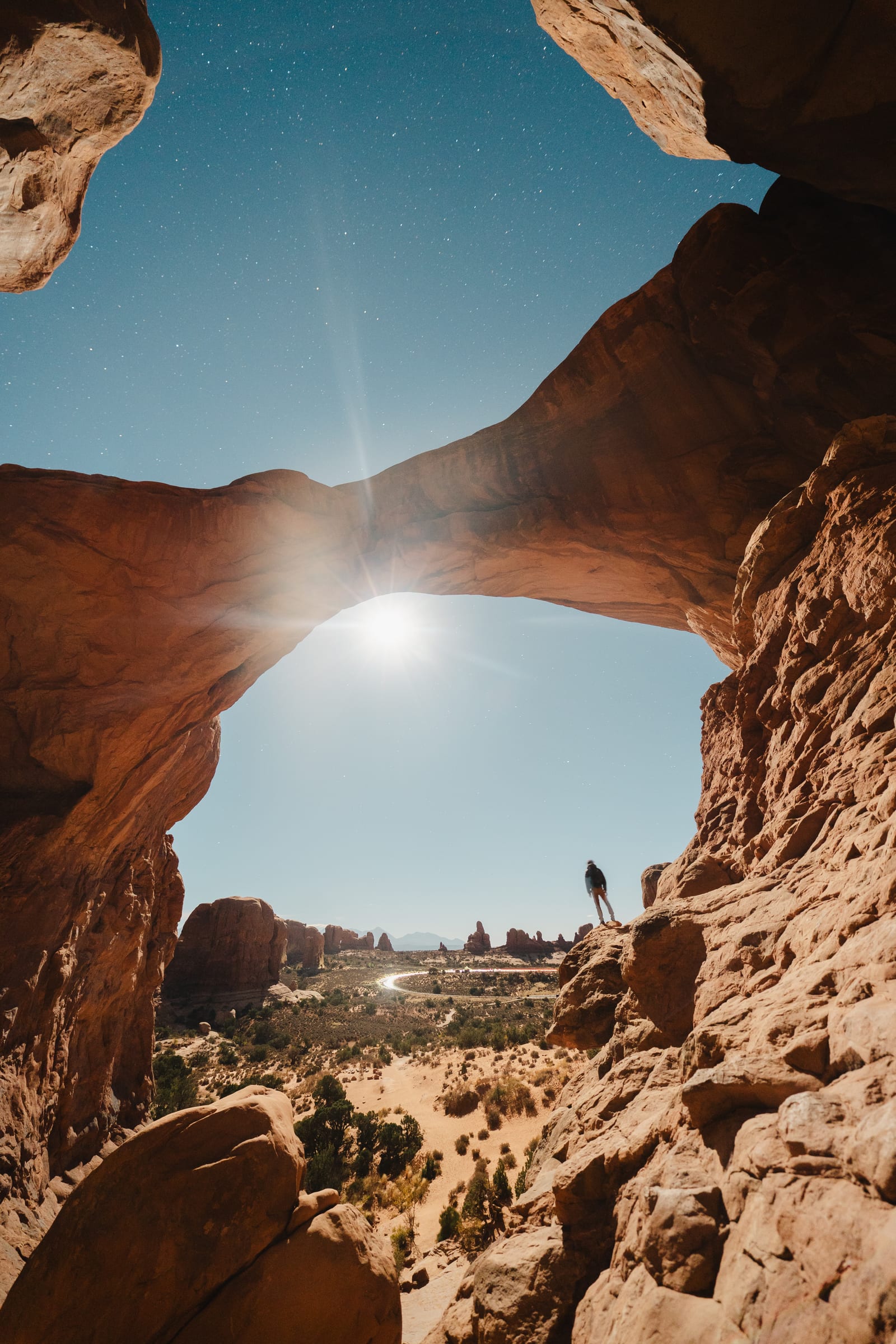 Double Arch framing sunstar and tiny figure