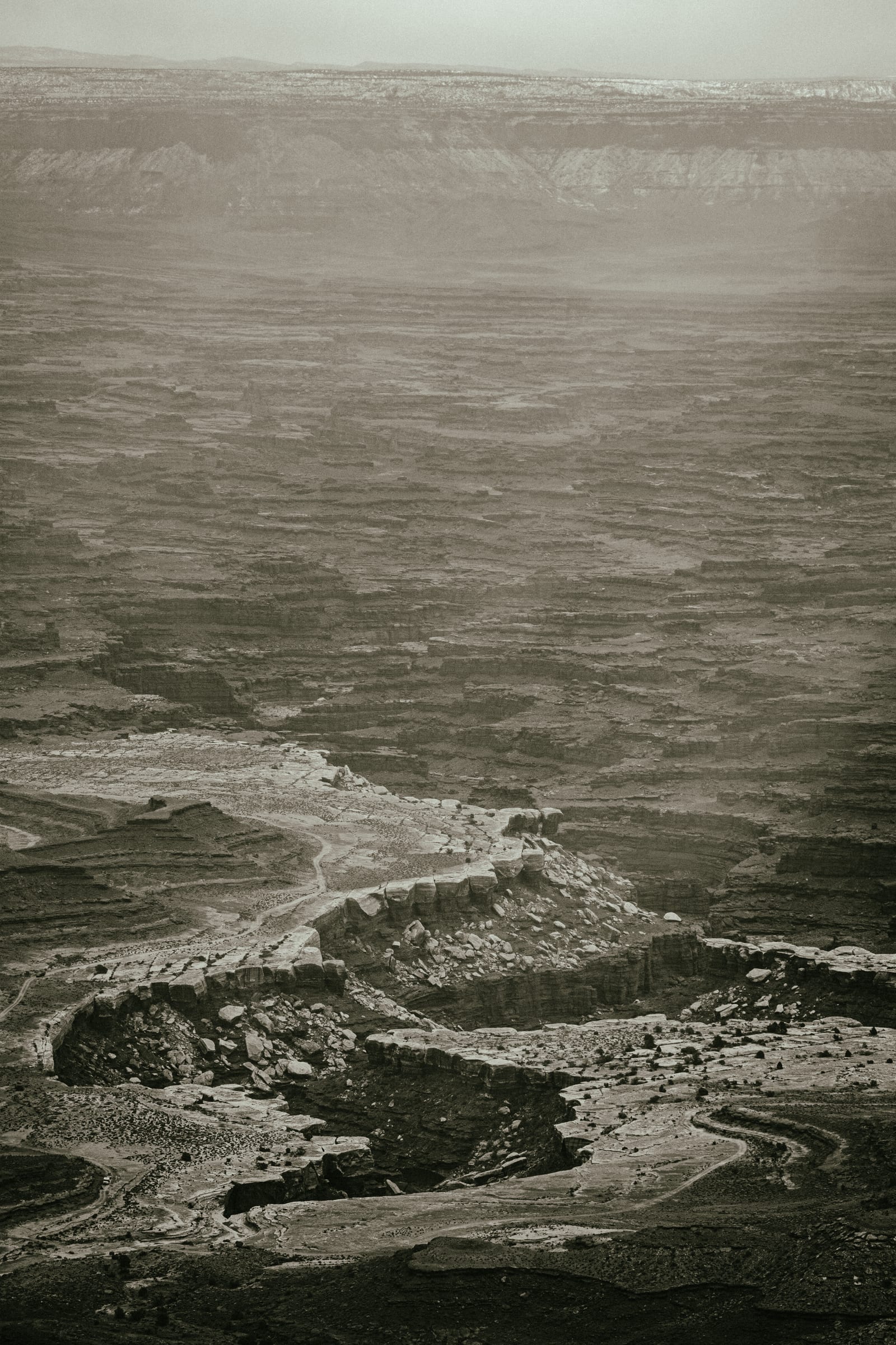 Sepia river bends receding into storm haze