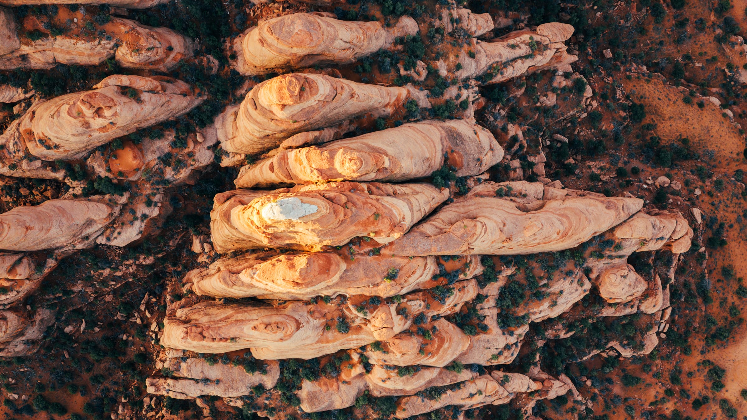 Drone straight down on pale Moab sandstone fins